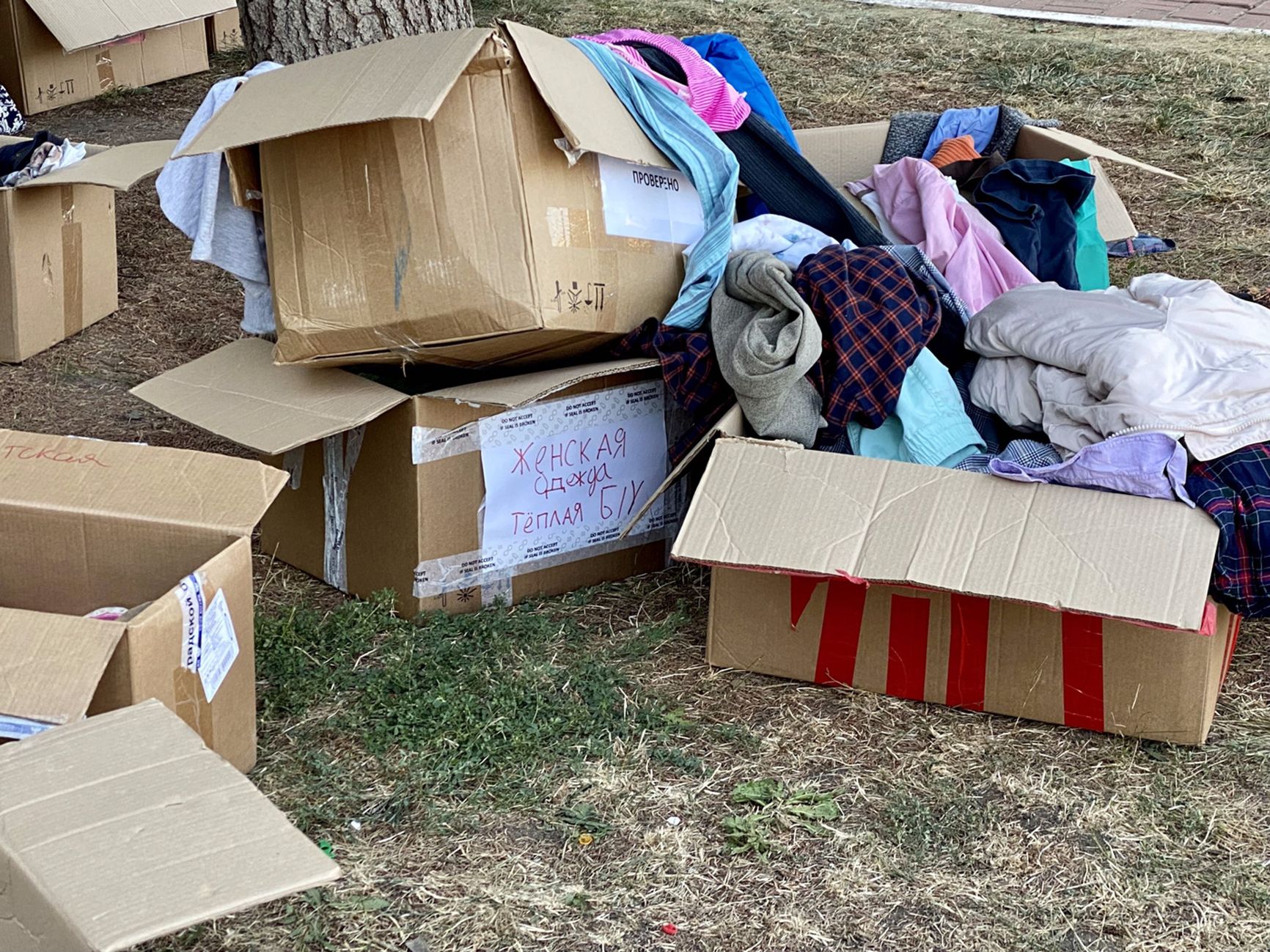 Donated clothes outside the circus. Many items look worn and used